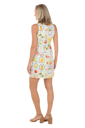 Woman wearing a sleeveless dress with fruit pattern on a white background