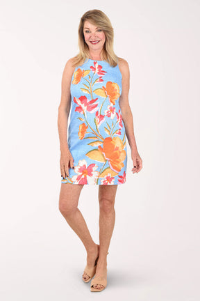Woman wearing a colorful floral dress on a white background