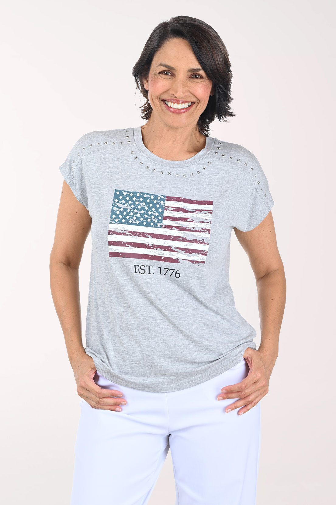 Woman wearing a gray t-shirt with an American flag design on a white background