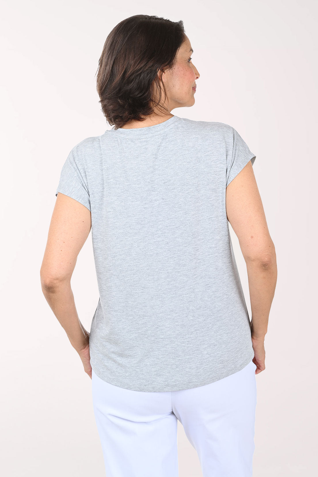 Woman wearing a gray t-shirt with an American flag design on a white background