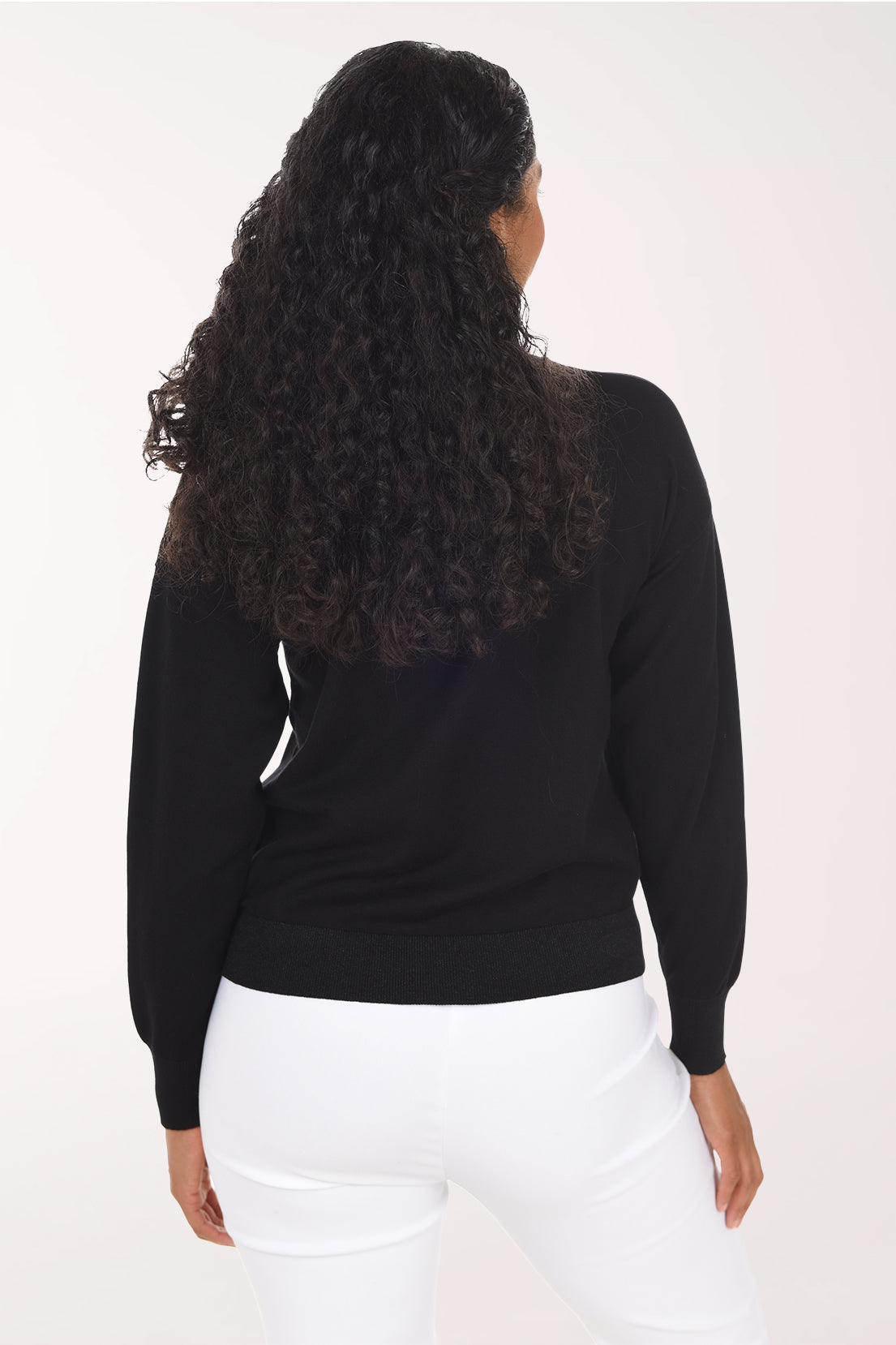 Back view of the plain black sweater with drop shoulders and a glitter ribbed hem.