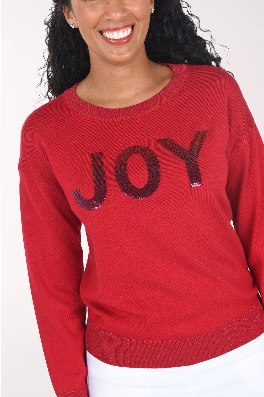 Close-up of the shimmering burgundy sequined "JOY" lettering and glitter ribbed crew neckline.