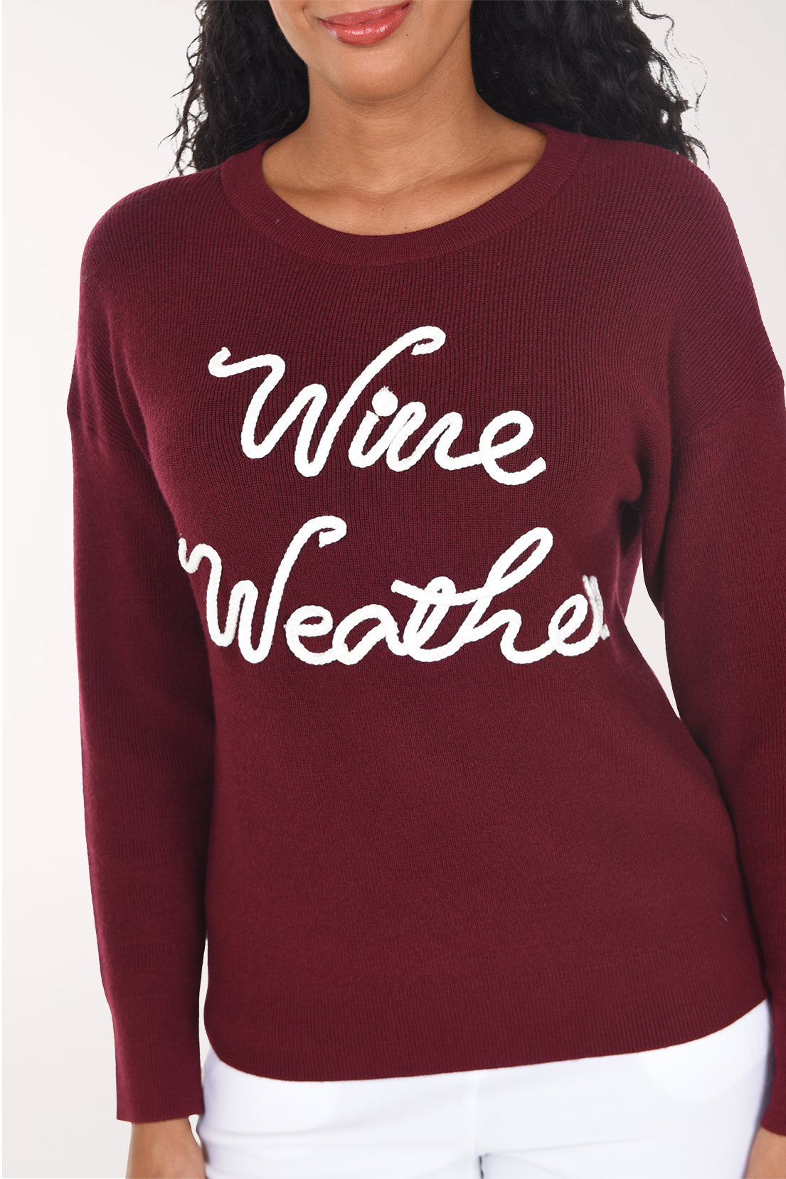 Close-up of the wine red rib knit showing the white braided soutache "Wine Weather" lettering.