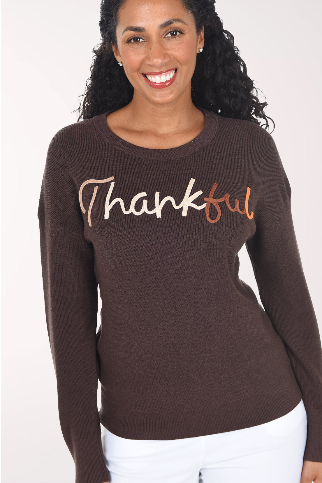 Close-up of the brown rib knit showing the two-tone blush and copper soutache "Thankful" lettering.