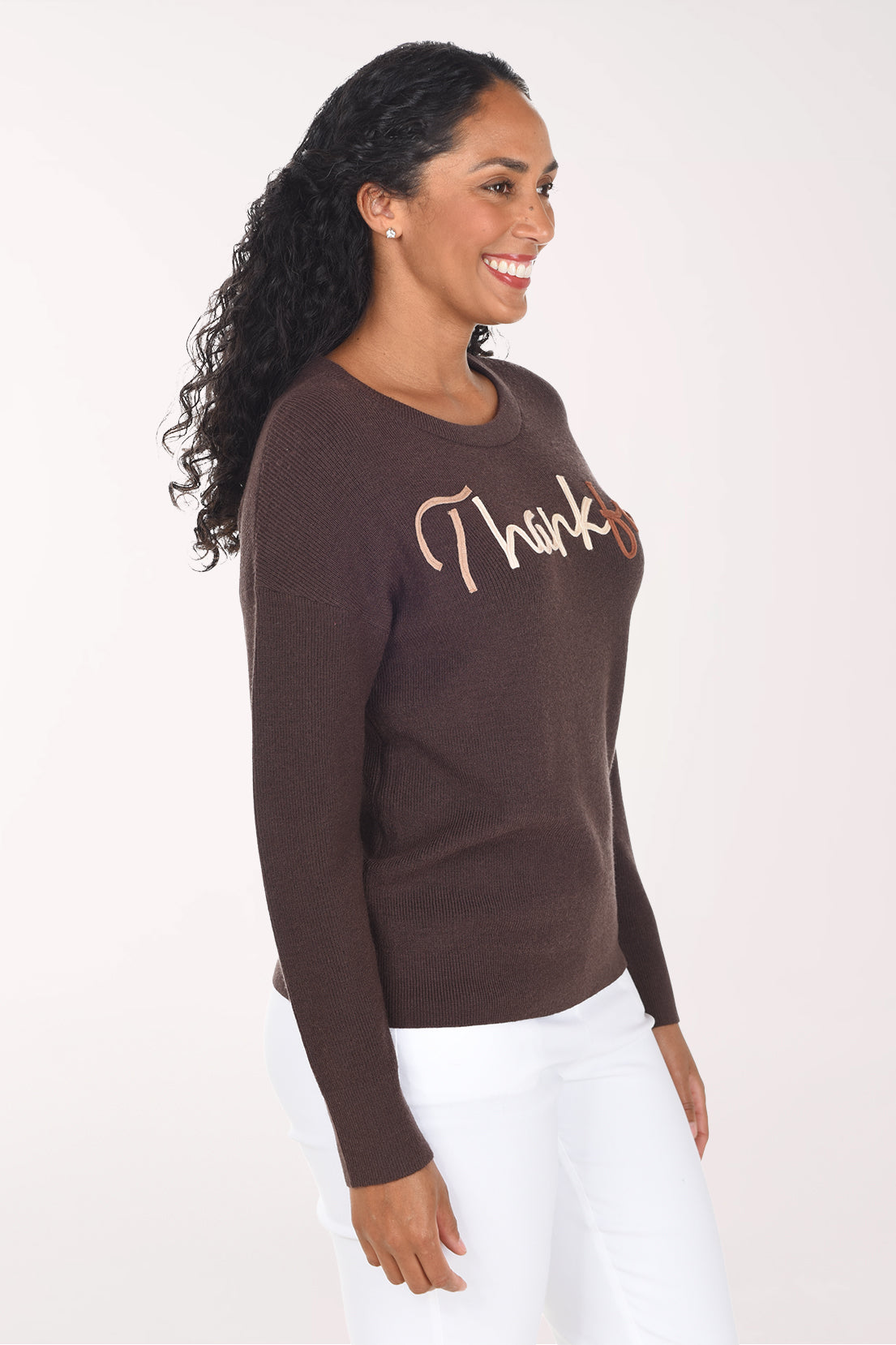 Side view of the chocolate brown sweater showing the drop shoulder and long cuffed sleeves.