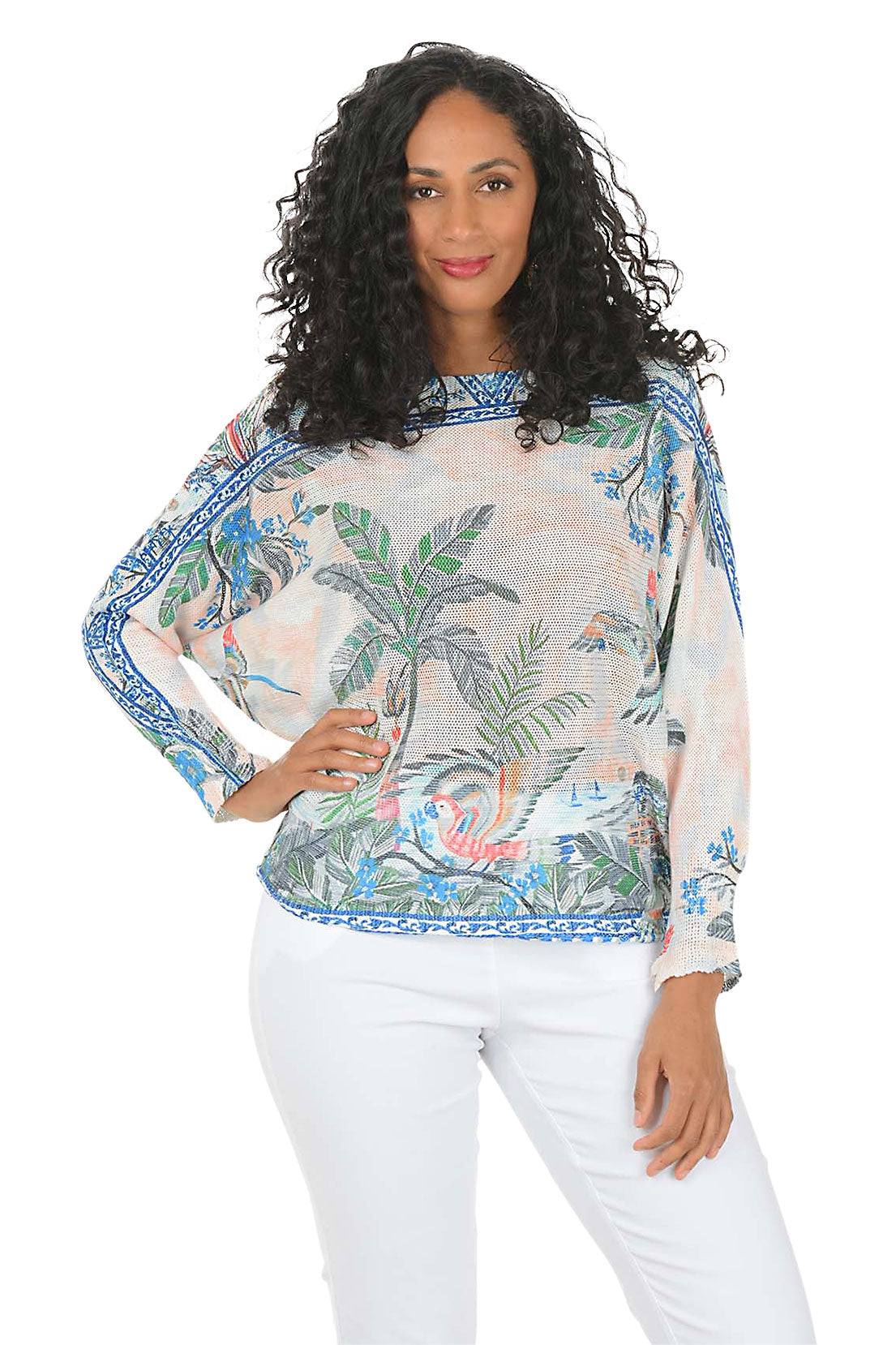 Woman wearing a tropical patterned blouse with palm trees and flowers on a white background.