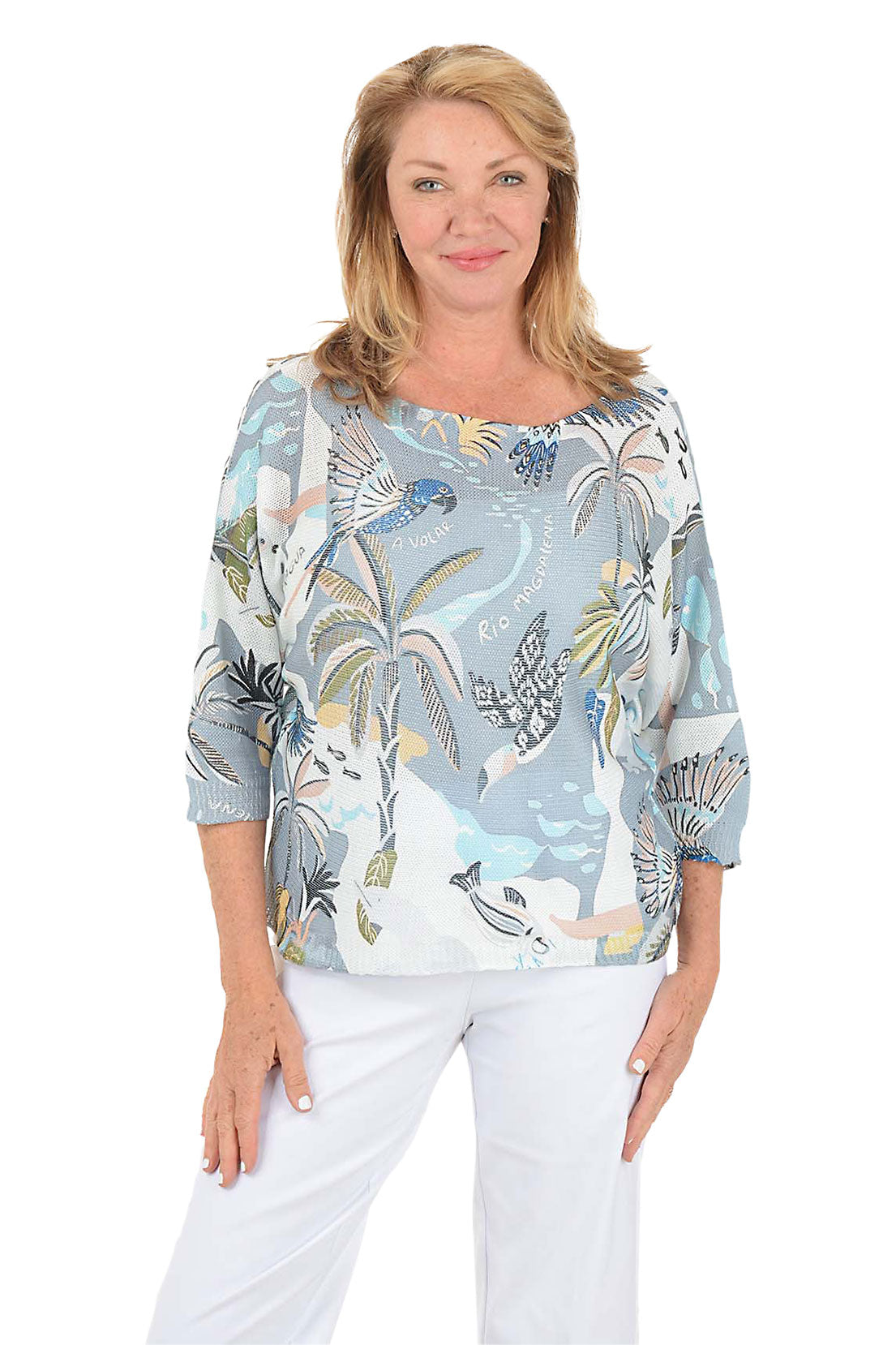 Woman wearing a patterned blouse with a white background.