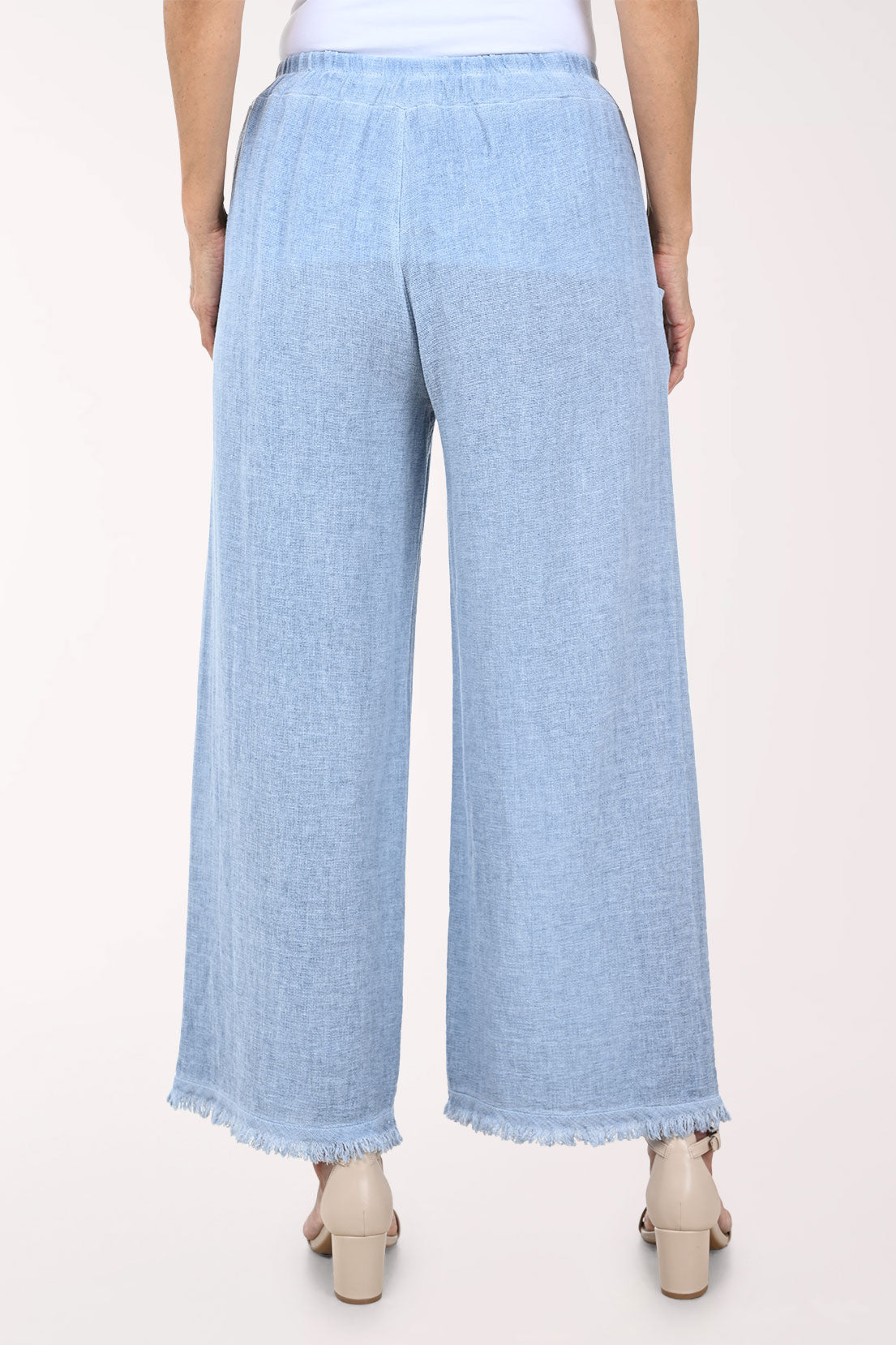 Light blue wide-leg pants worn by a person on a white background