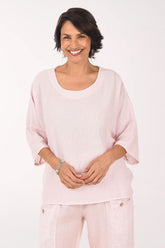 Woman wearing a light pink outfit on a white background