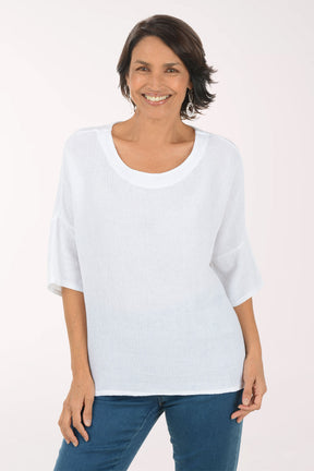 Woman wearing a white top and blue jeans on a white background