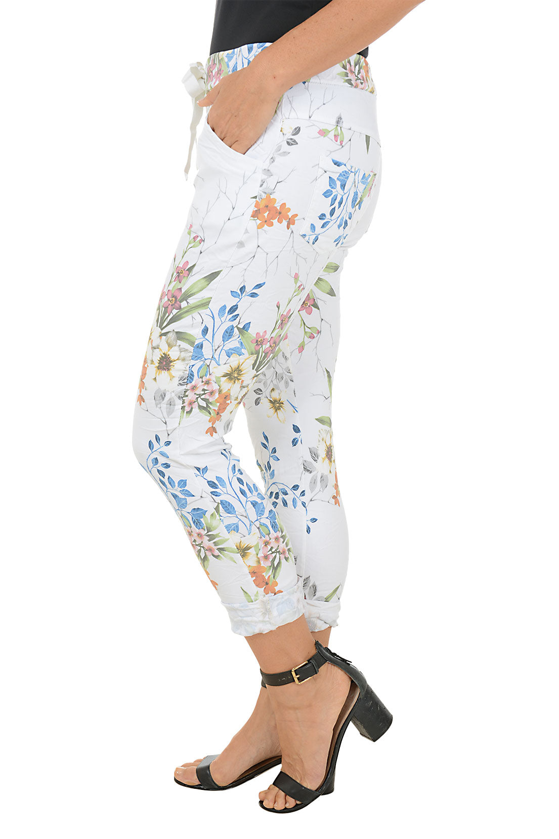 Floral-patterned pants worn by a person on a white background. Side shot.