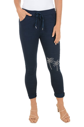 Navy blue pants with palm tree design on a white background.