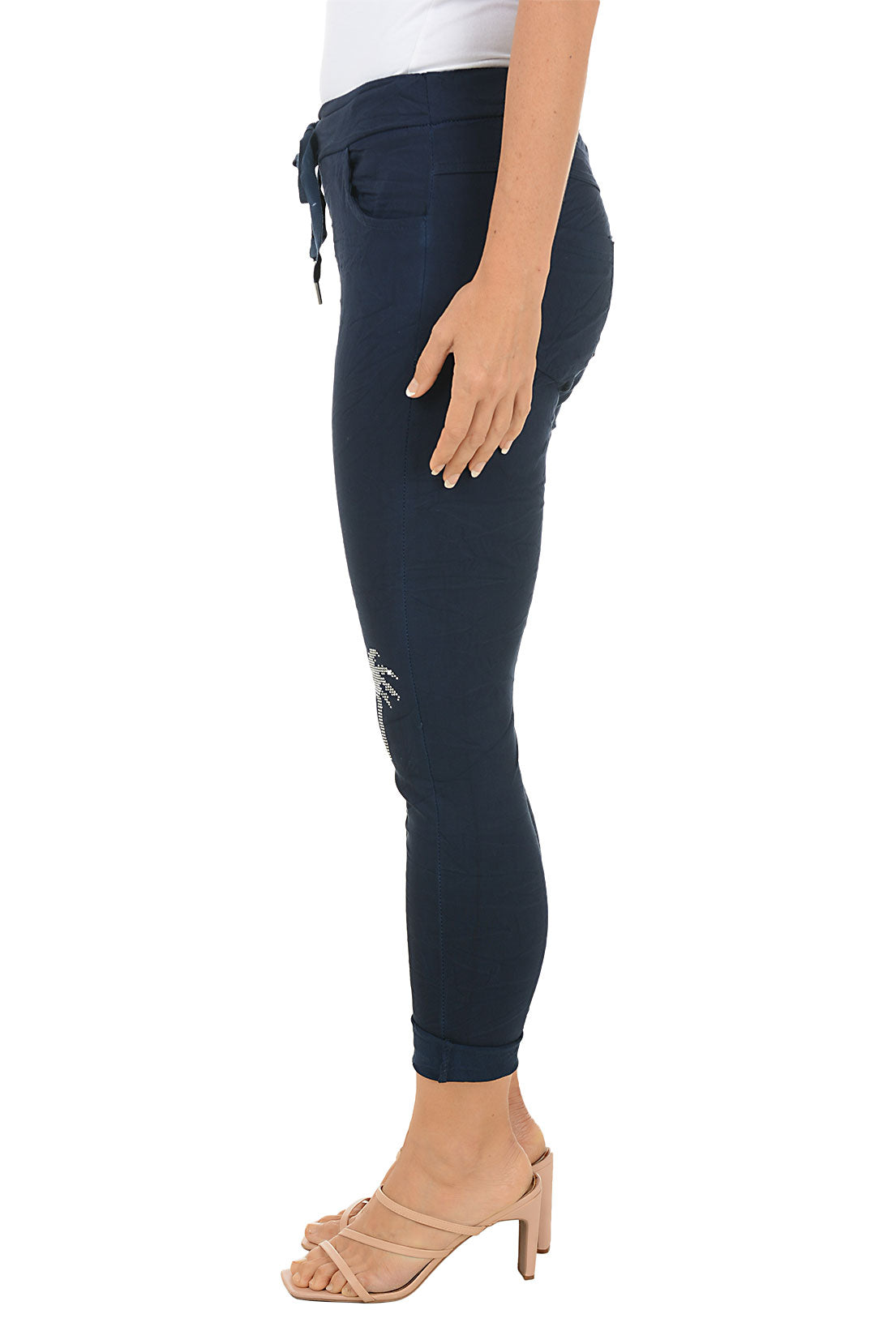 Navy blue pants with palm tree design on a white background. Side shot.