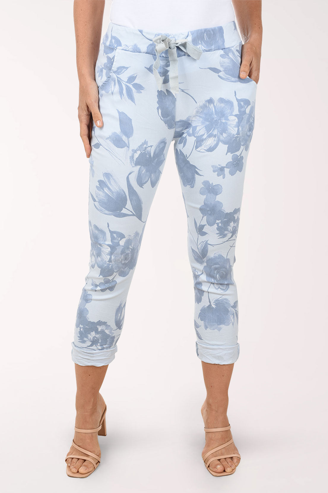 Light blue floral-patterned pants worn by a person on a white background