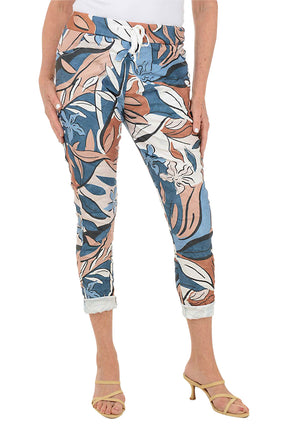 Multicolored floral-patterned pants worn by a person on a white background.