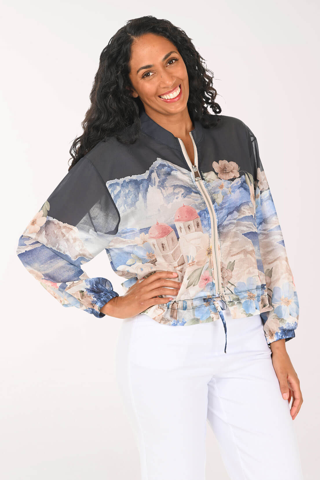 Woman wearing a colorful floral-patterned jacket on a white background