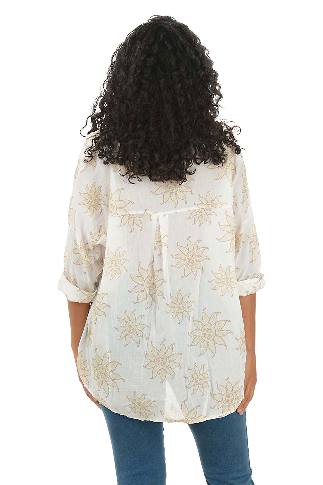 Woman wearing a white blouse with floral patterns and blue jeans on a white background. Back shot.
