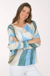 Woman wearing a slouchy blue sweater.