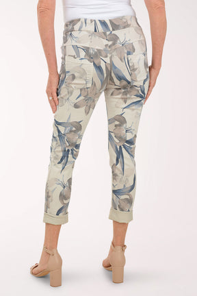 Woman wearing beige joggers with multicolored flowers.