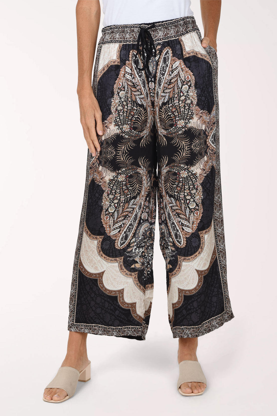 Woman wearing black paisley flared pants 