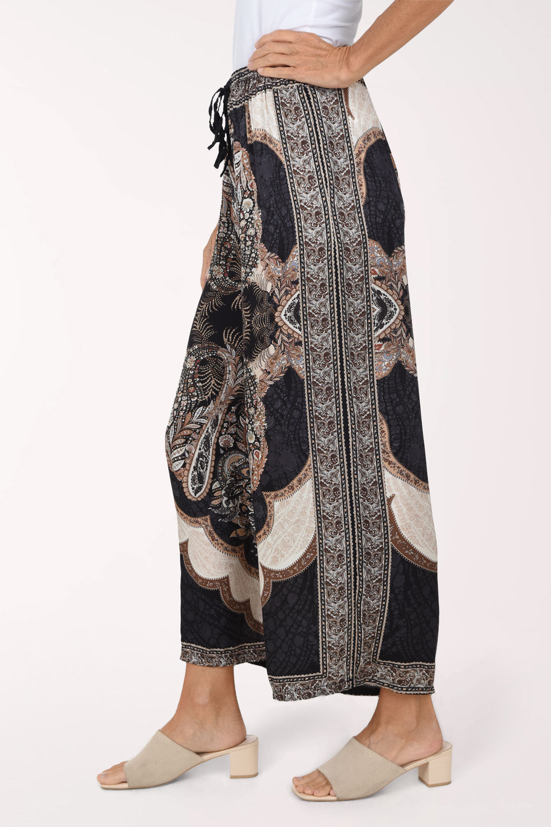 Woman wearing black paisley flared pants 