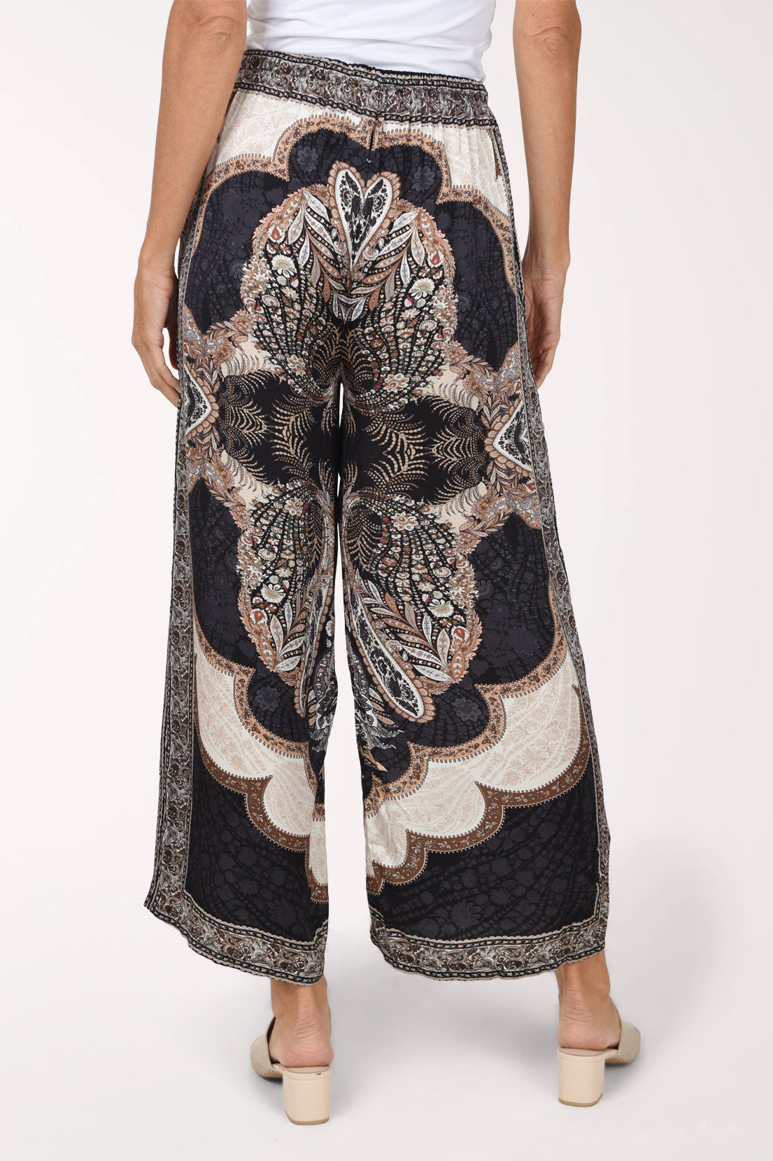 Woman wearing black paisley flared pants 