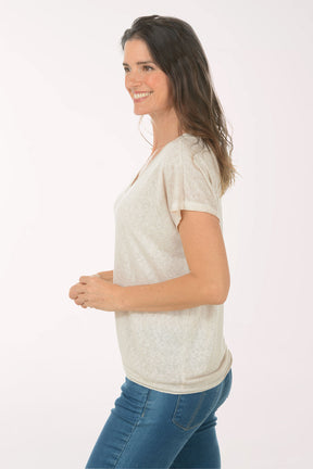 Woman wearing a short sleeve v-neck beige tee.