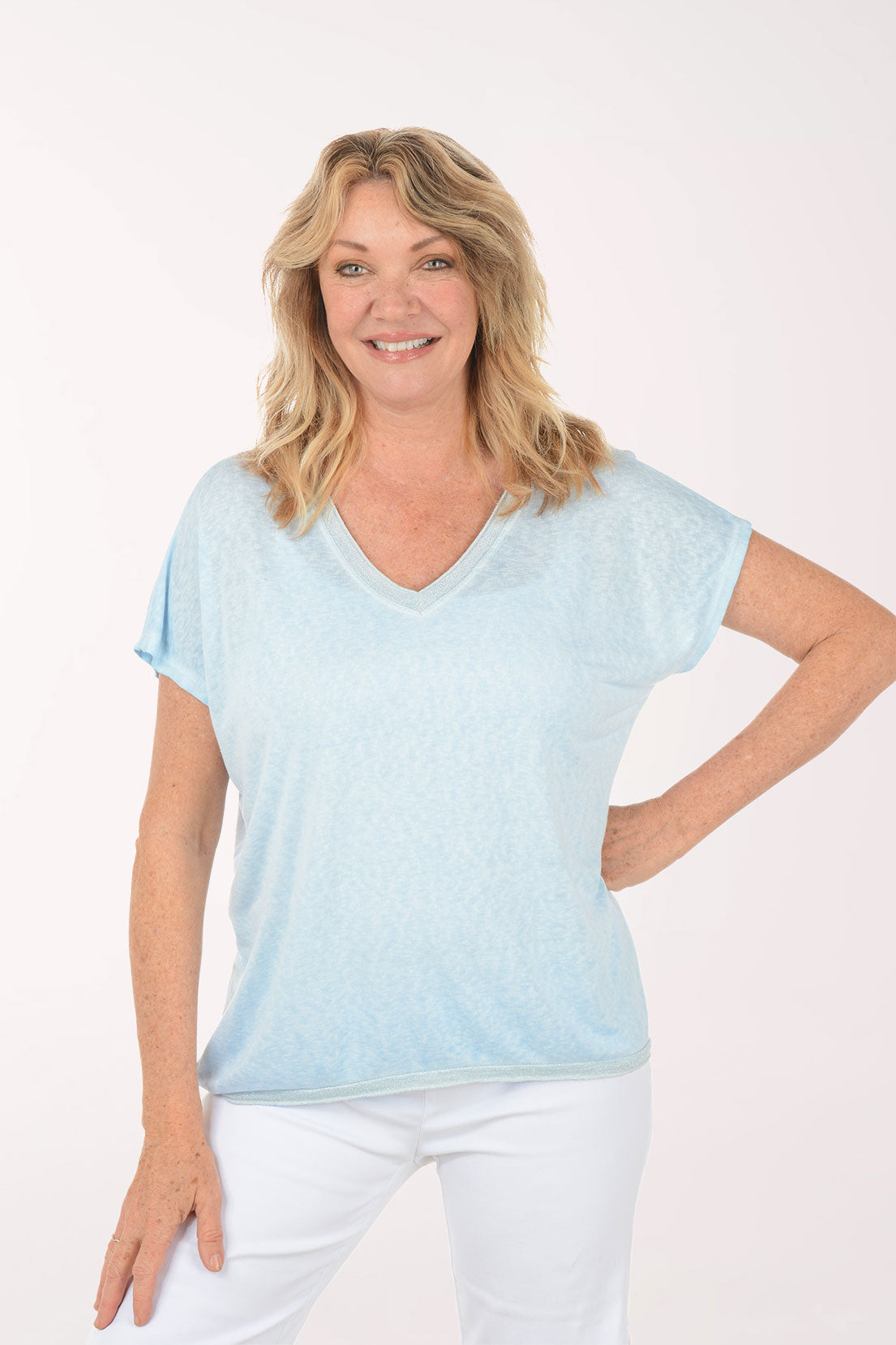 Woman wearing a short sleeve v-neck blue tee.