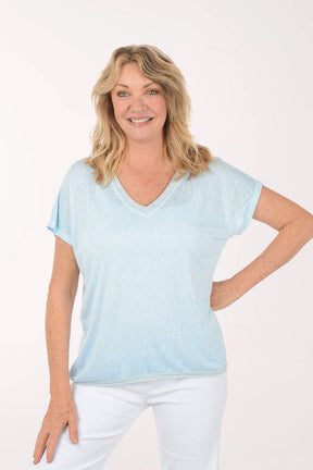 Woman wearing a short sleeve v-neck blue tee.