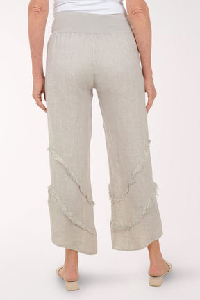 Woman wearing beige flowy pants.