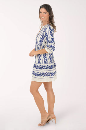 Woman wearing a blue and white patterned dress on a white background