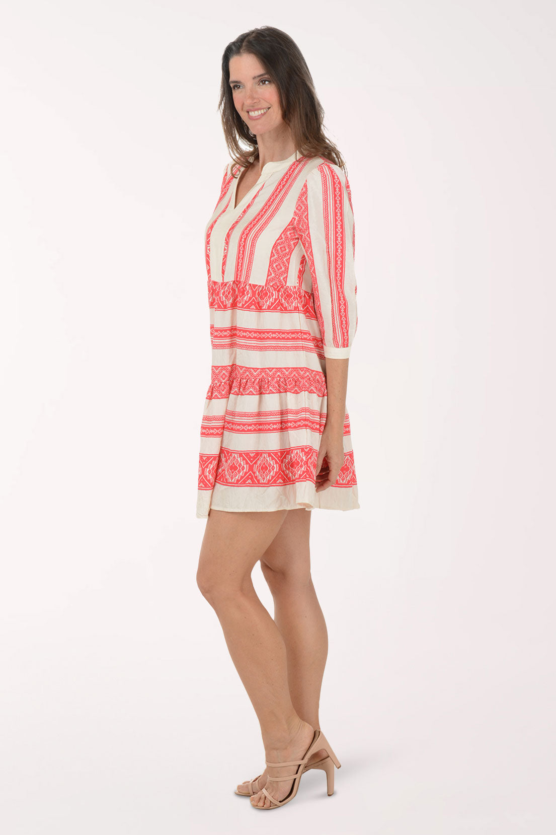 Woman wearing a red and white patterned dress on a white background