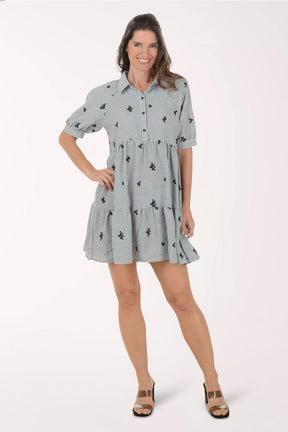 Woman wearing a black and white dress with floral pattern on a white background