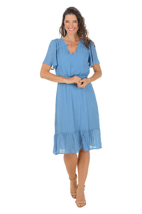 Woman wearing a blue dress on a white background.
