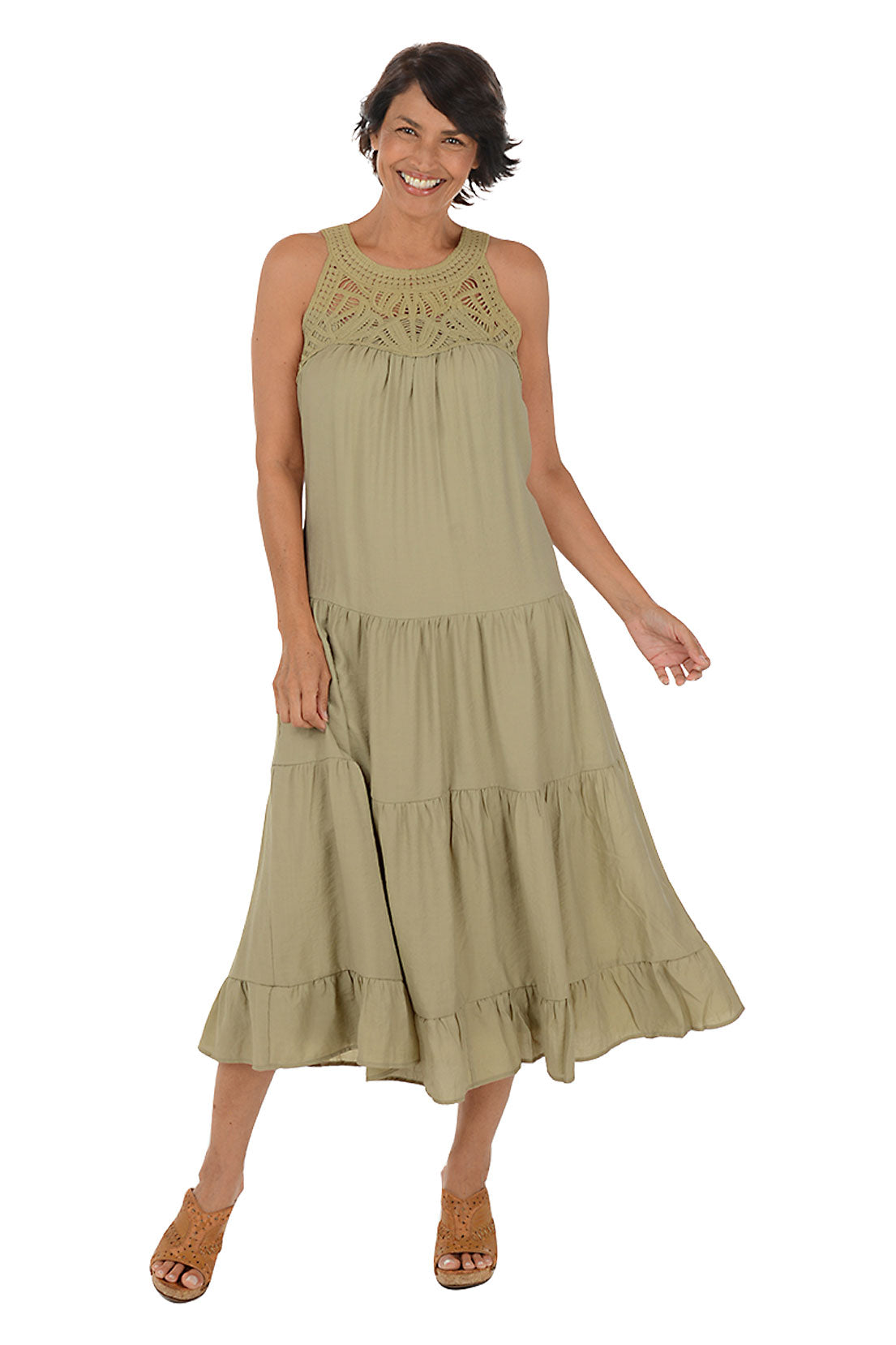 A woman wearing a khaki halter midi dress with a crochet neckline. 