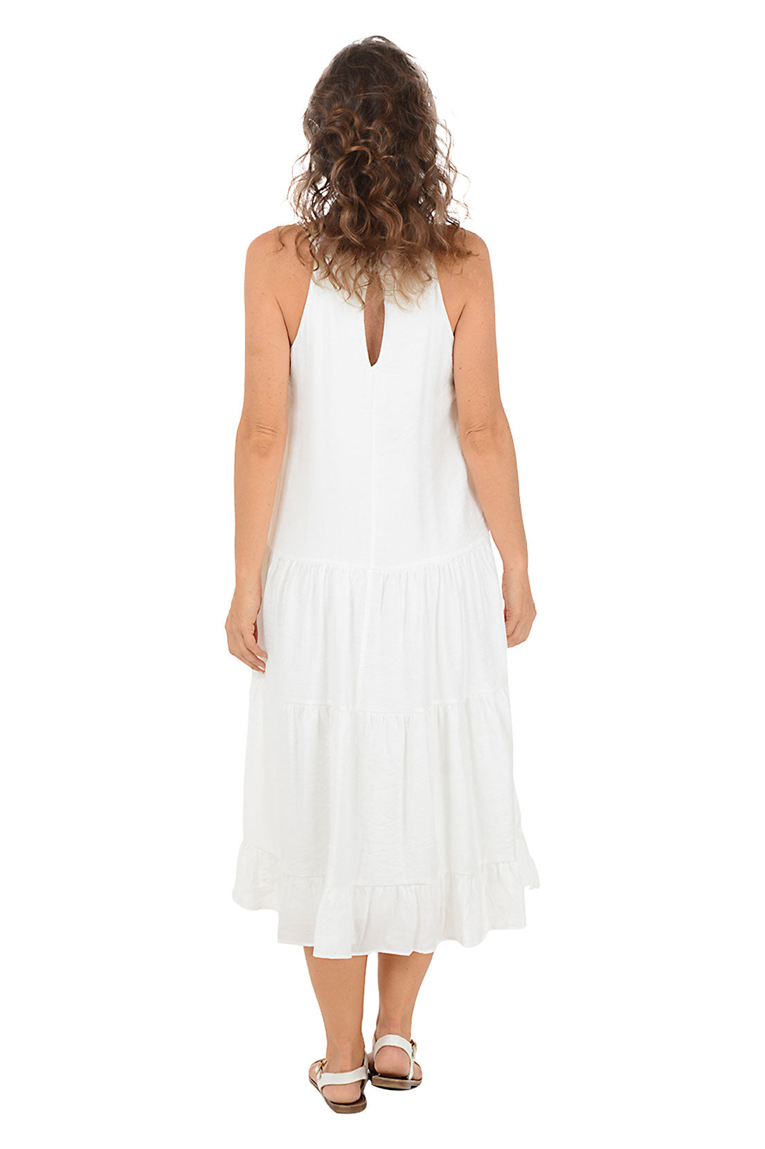 A woman wearing a white halter midi dress with a crochet neckline.  Back shot.