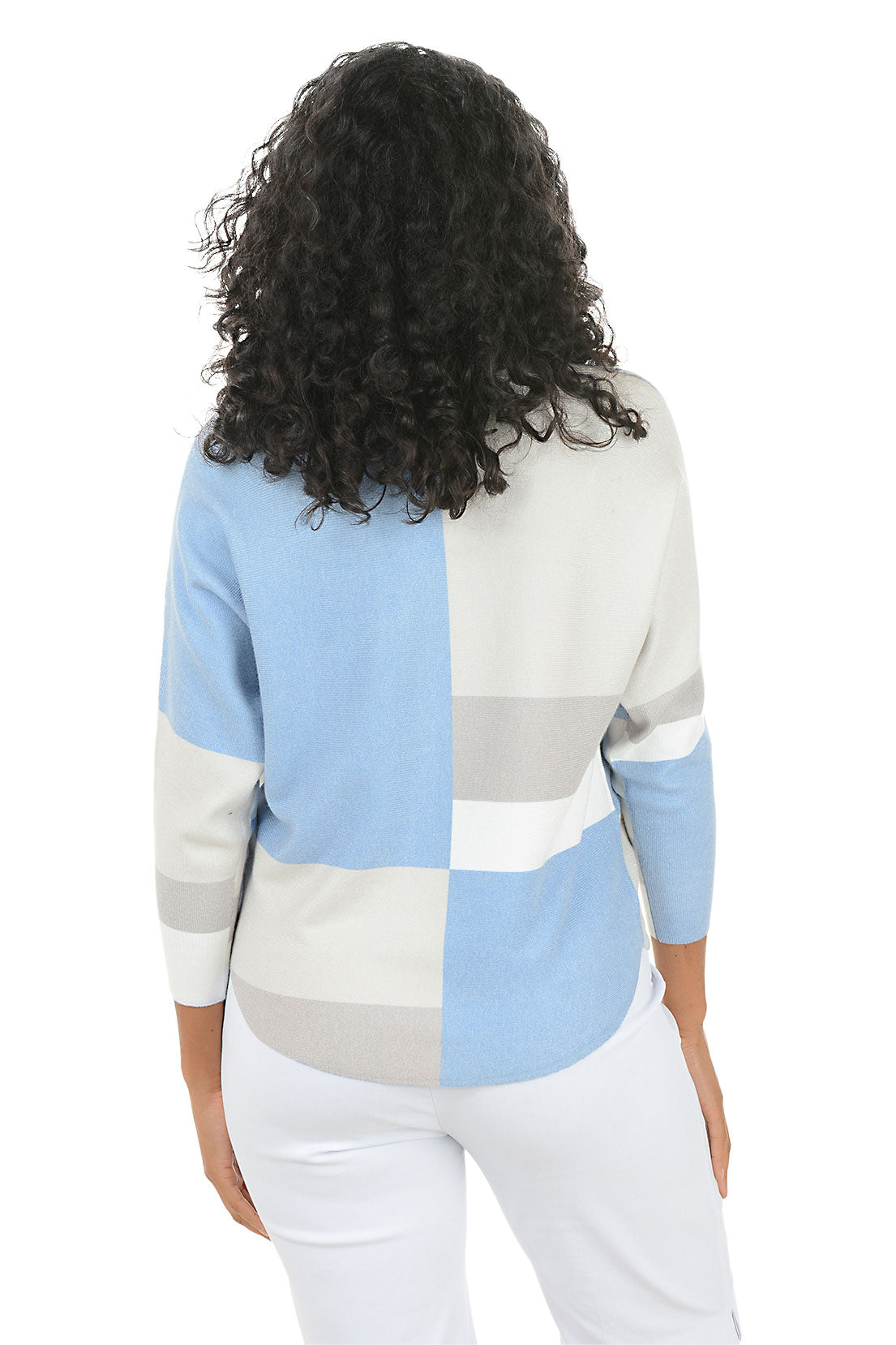 Woman wearing a blue and grey geometric block sweater with dolman sleeves on a white background. Back shot.