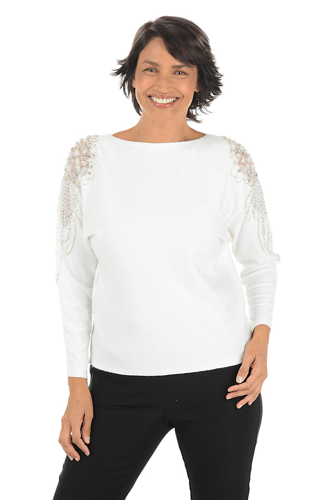 Woman wearing a white long sleeve sweater with sheer mesh angel wing embellishments with beaded and rhinestone accents on shoulders.