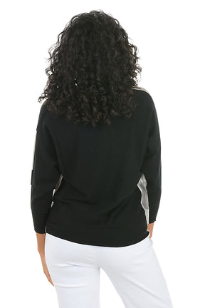 Woman wearing a black, gray, and white color-blocked sweater on a white background. Back shot.