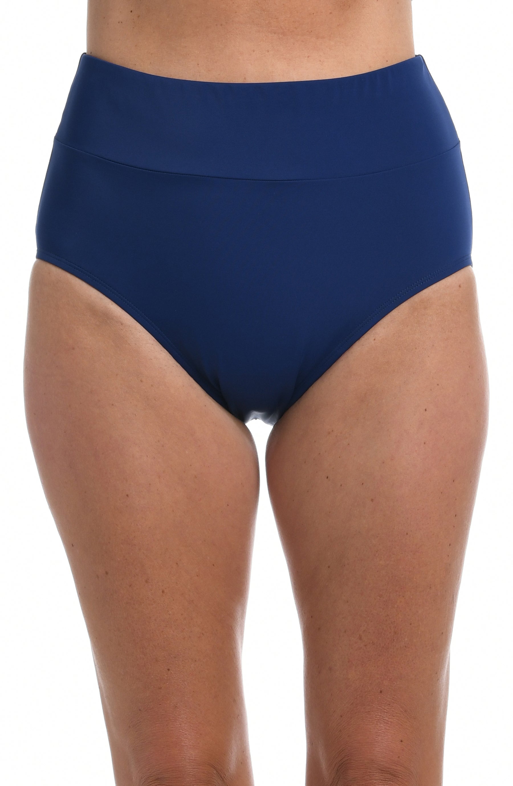 Person wearing navy mid-waist bikini bottoms on a white background.