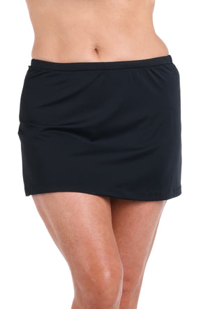 Black skirt worn by a person on a white background