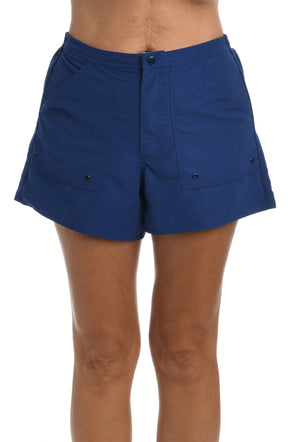 Navy blue woven swim shorts worn by a person on a white background.