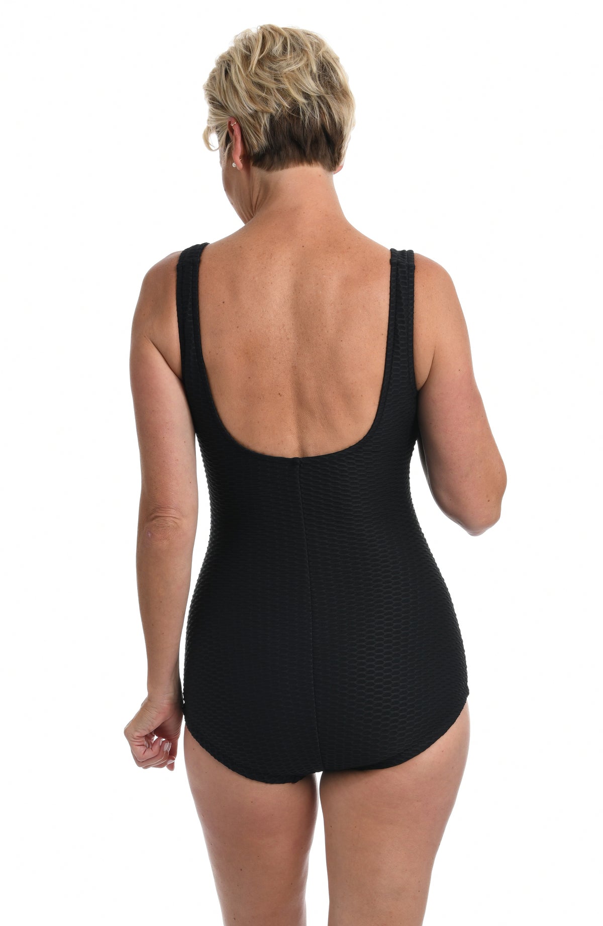 Black swimsuit worn by a person on a white background.