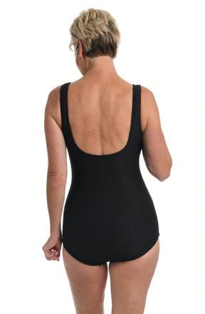Black swimsuit worn by a person on a white background.