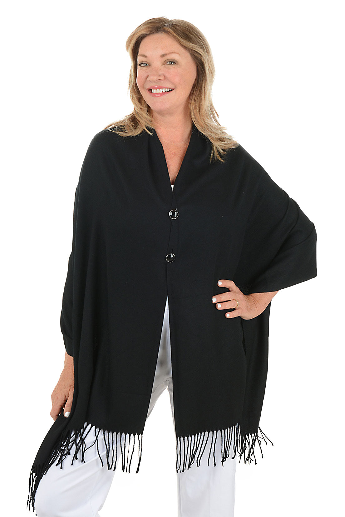 Woman wearing a black shawl with fringes on a white background.