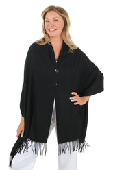 Woman wearing a black shawl with fringes on a white background.