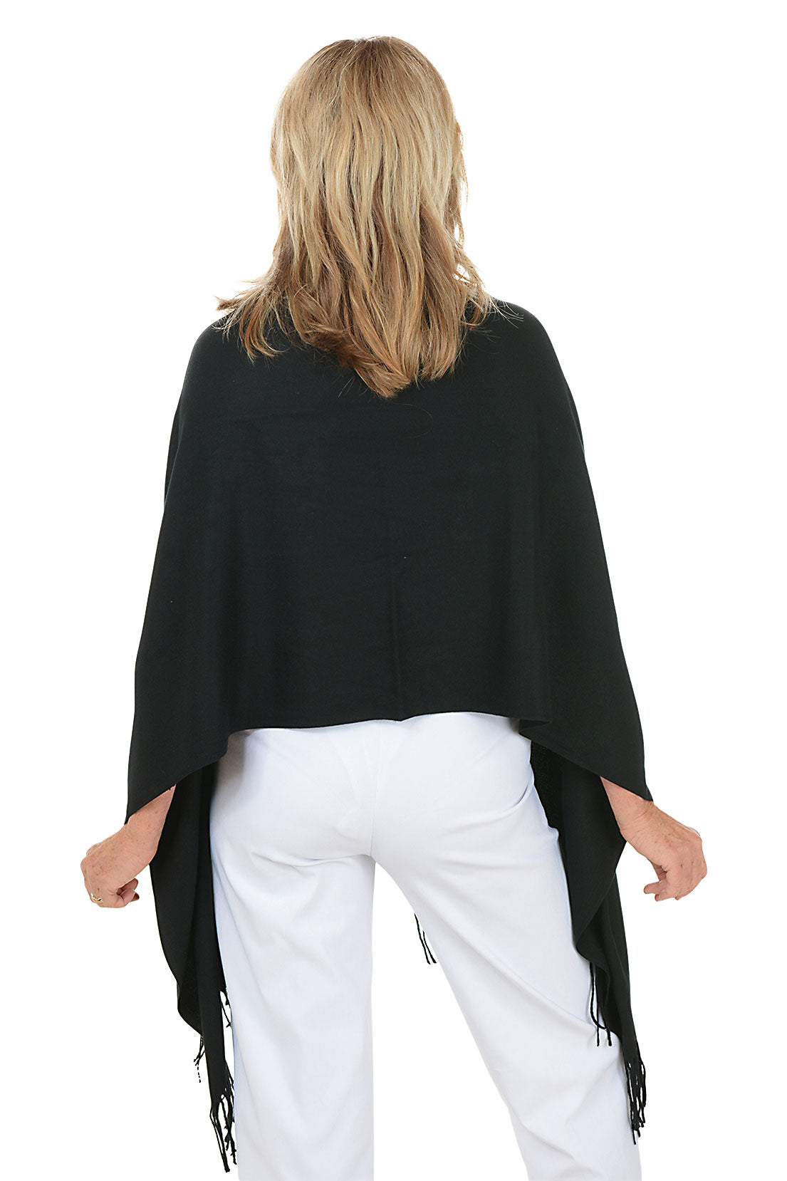 Woman wearing a black shawl with fringes on a white background. Back shot.