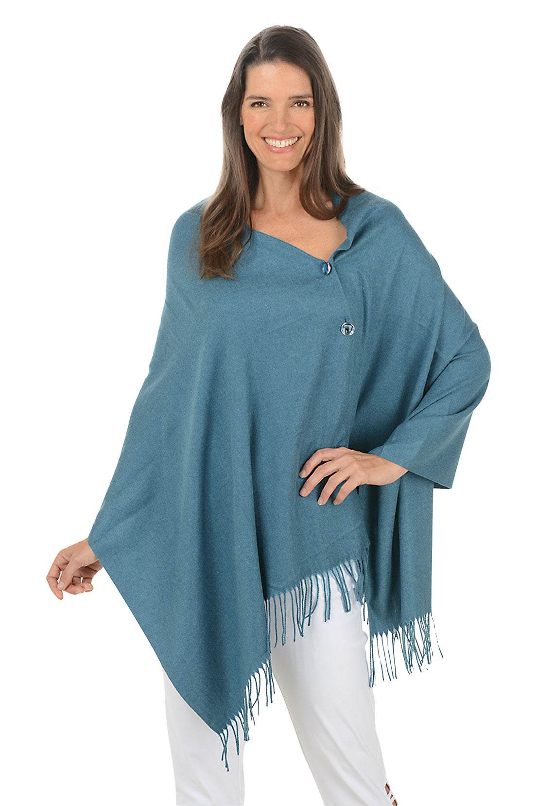 Woman wearing a blue shawl with white pants on a white background