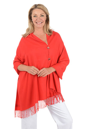 Woman wearing a red shawl with fringes on a white background