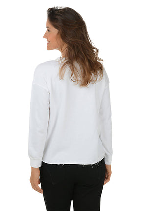 A woman wears a white sweatshirt with a dog print against a white background. Back shot.
